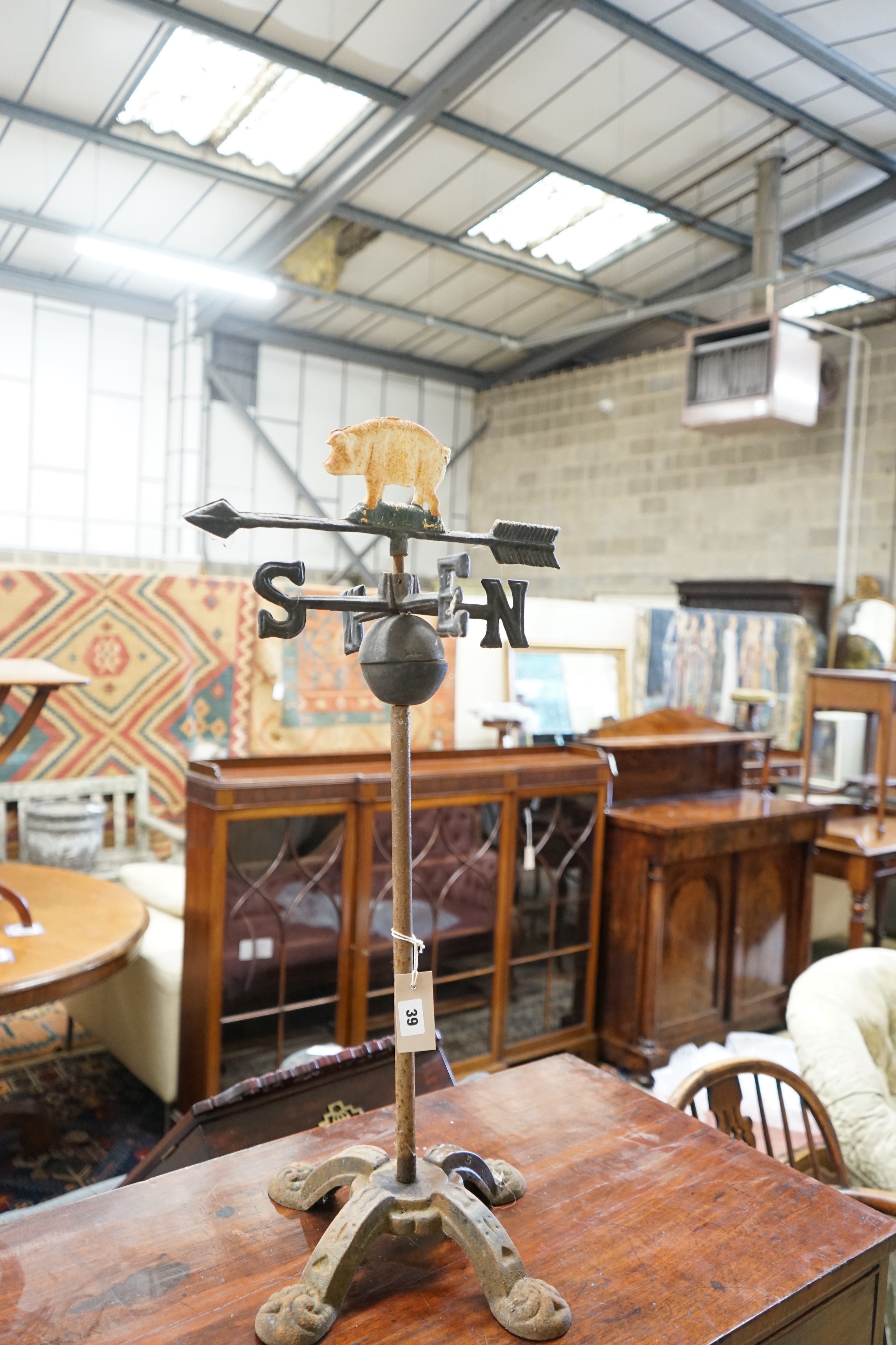 A painted metal pig weather vane on associated stand, height 76cm